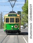 Green-yellow W8-class electric tram operating on the zero-fare, number 35 City Circle tourist route. The W-class was introduced in 1923 by MMTB and has seen several updates. Melbourne-VIC-Australia.