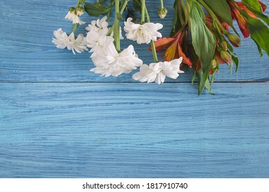 Greeting card with bouquet of white chrysanthemums on blue paint wooden background. Space for text, top view - Powered by Shutterstock