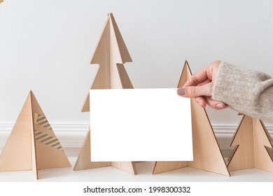 Greeting card in front of a paper Christmas tree mockup