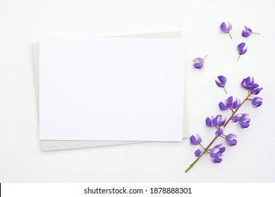 Greeting card, invitation card mockup, horizontal empty paper with envelope and purple flower.	