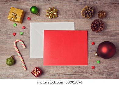 Greeting Card Mock Up Template With Christmas Decorations On Wooden Background. View From Above