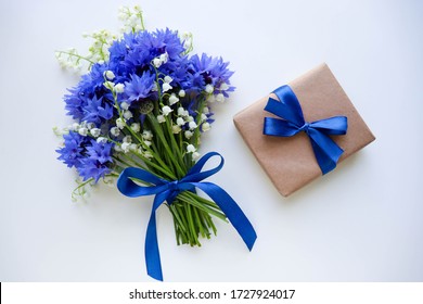 greeting card mockup. bouquet of blue cornflowers on a white background. congratulation. invitation. flat lay