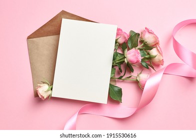 Greeting Card Mockup With Copy Space, Pink Ribbon And Roses Flowers On Paper Background