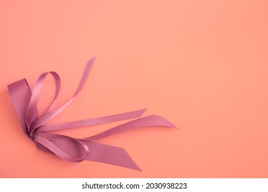 Greeting Card Mockup With Gentle Ribbon Bow On Pastel Pink Background.