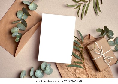 Greeting Card Mockup With Gift Box, Envelope And Natural Eucalyptus Twigs On Paper Background