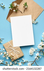 Greeting Card Mockup With Gift And White Flowers On Blue