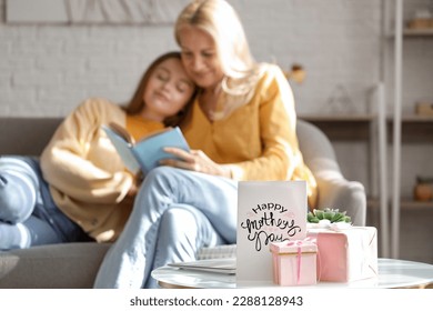 Greeting card for Mother's Day, gifts and laptop on table in room, closeup - Shutterstock ID 2288128943