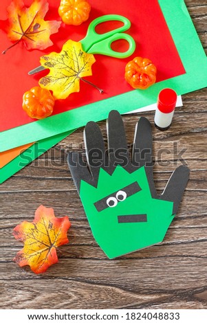 Greeting card with pumpkin halloween on wooden table. Children's creativity project, crafts, crafts for kids.
