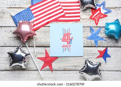 Greeting card with text HAPPY 4TH JULY, balloons and USA flags on white wooden background