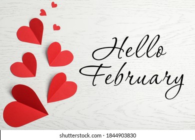 Greeting card with text Hello February. Red paper hearts on white wooden background, flat lay - Shutterstock ID 1844903830