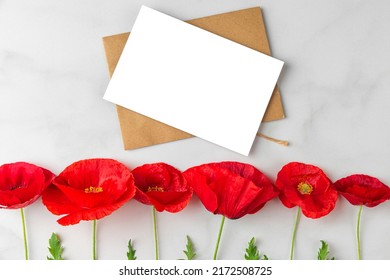 Greeting Or Invitation Card With Red Poppy Flowers On White Marble Background. Mock Up. Flat Lay. Holiday Concept