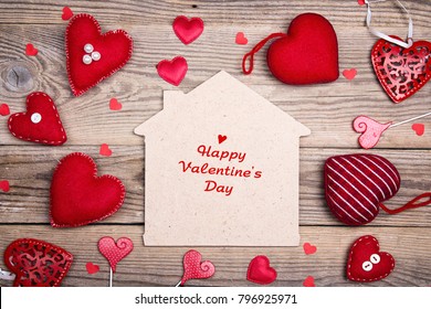 Greeting Valentines Day Card With Home Symbol And Red Hearts On Wooden Background. Happy Valentine's Day.