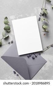 Greeting Or Wedding Invitation Card Mockup With Envelope, Lavender And Dry Eucalyptus Twigs On Grey, Top View, Copy Space