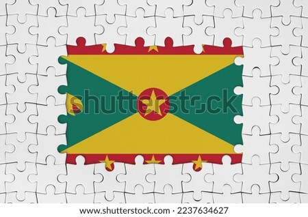 Grenada flag in frame of white puzzle pieces with missing central parts