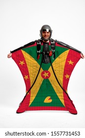 Grenada Flag Travel. Bird Men In Wing Suit Flag. Sky Diving Men In Parashute. Patriotism, Men And Flag.
