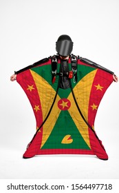 Grenada Flag Travel. Bird Men In Wing Suit Flag. Sky Diving Men In Parashute. Patriotism, Men And Flag.
                              