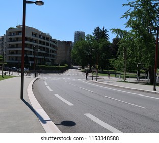 Grenoble, France – June 10, 2017: Photography Depicting Policemen Blocking A Street And Ensuring The Security And Safety During The Cycling Event 'Le Critérium Du Dauphiné 2017'. 