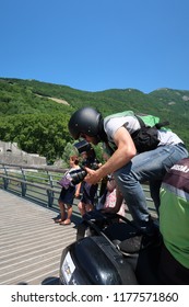 Grenoble, France – June 10, 2017: Photography Depicting A Professionnal Photograph Climbing On A Motorcycle To Take A Picture During The Cycling Event 'Le Critérium Du Dauphiné 2017'