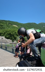 Grenoble, France – June 10, 2017: Photography Depicting A Professionnal Photograph Climbing On A Motorcycle To Take A Picture During The Cycling Event 'Le Critérium Du Dauphiné 2017'