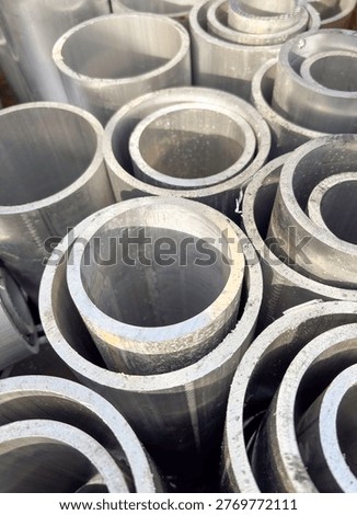 Grey aluminium tubes in an abstract pattern 