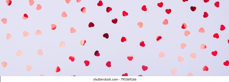 Grey Background With Red Glitter Heart Confetti. Valentine Day Concept. Trendy Minimalistic Flat Lay Design Background. Horizontal, Banner Format