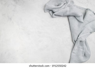 Grey  background with grey  textile napkin. Food background for recipe, cooking ingredients and restaurant design with copy space for text