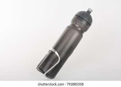 Grey Bike Water Bottle Inserted To Holder, Studio Photo, Isolated On White Background. 