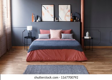 Grey Blanket On Pink Bed Against The Wall With Poster In Modern Bedroom Interior