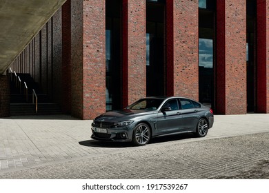 Grey BMW 430i, 252 HP, standing in front of NOSPR building - one of the most modern concert halls in europe. Katowice, Poland-06.30.2017