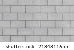 Grey brick wall background close up. Gray stone tile block background with horizontal texture of gray brick. Gray brick surface.