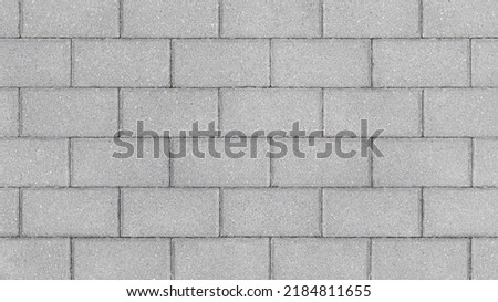 Grey brick wall background close up. Gray stone tile block background with horizontal texture of gray brick. Gray brick surface.