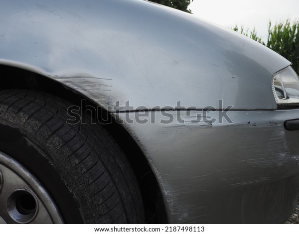 grey car\
body with surface scratches on primer\
layer