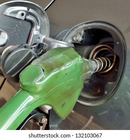 Grey car at gas station being filled fuel - Shutterstock ID 132103067