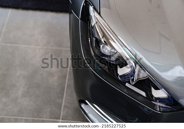 grey car headlight. sale of cars.\
dealership. rent and sale of high-class\
cars.