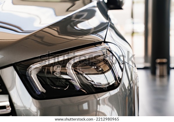 grey car headlight. sale of cars.\
dealership. rent and sale of high-class\
cars.