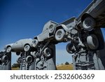 Grey cars stacked on top of each other in the middle of nowhere Nebraska as a tribute to Stonehenge in the U.K.