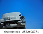 Grey cars stacked on top of each other in the middle of nowhere Nebraska as a tribute to Stonehenge in the U.K.