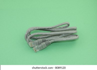 Grey Category 5 Cable Set Against A Green Background