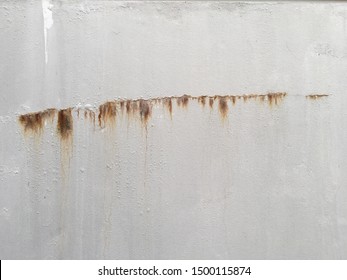 Grey Cement Wall With Red Rust Dripping Down