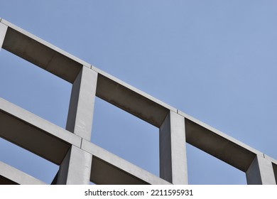 Grey Concrete Architectural Building Frame Against Cool Blue Sky