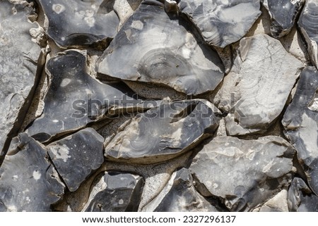 Grey flint stone background texture. Hard rock surface backdrop 