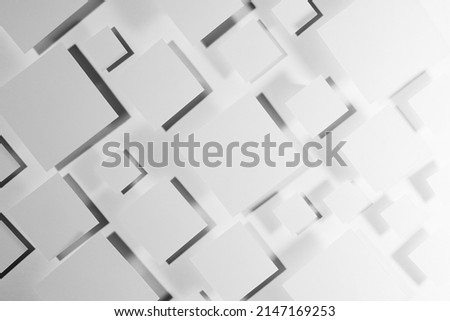 Grey geometric texture with flying rhombuses in hard light with contrast gradient dark shadows as random pockmarked pattern, top view. Simple abstract background in minimal style.