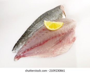 Grey Gilthead Seabream Fillet with Lemon isolated on white Background