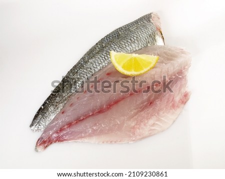 Grey Gilthead Seabream Fillet with Lemon isolated on white Background