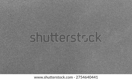 Grey gritty texture creating an abstract noise background surface