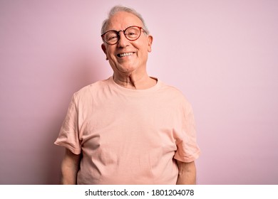 Grey haired senior man wearing glasses standing over pink isolated background with a happy and cool smile on face. Lucky person. - Powered by Shutterstock