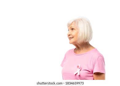 Grey Haired Woman With Ribbon Of Breast Cancer Awareness On T-shirt Looking Away Isolated On White