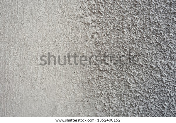 Grey hammer painted rough cement concrete wall\
background. 
