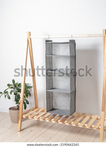 Grey hanging organizer for clothes. Storage
system for wardrobe