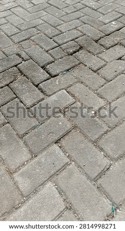Grey herringbone paving block texture outdoor walkway surface
